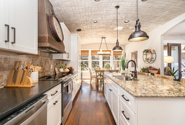 kitchen with brick ceiling, appliances with stainless steel finishes, extractor fan, and a sink