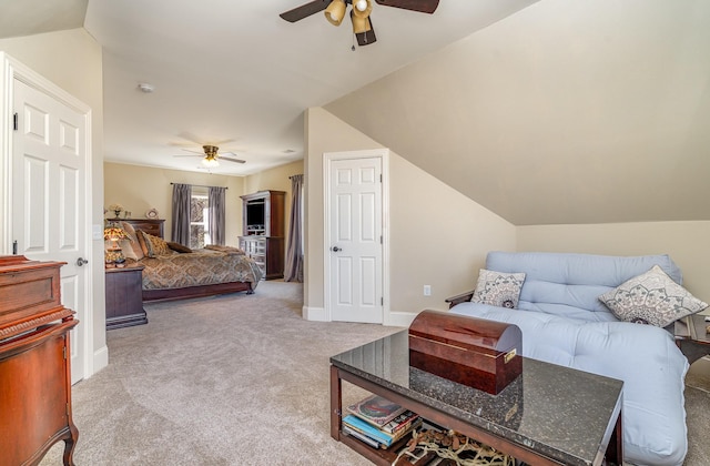 bedroom with a ceiling fan, carpet flooring, vaulted ceiling, and baseboards