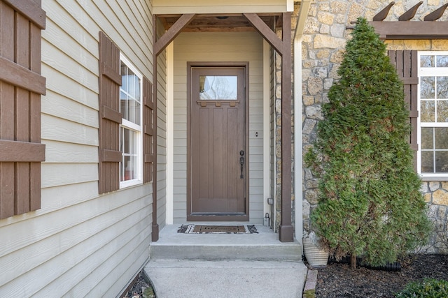 property entrance with stone siding