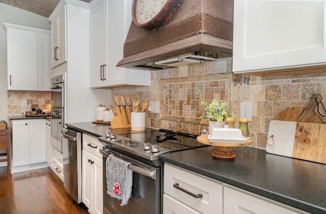 kitchen featuring premium range hood, appliances with stainless steel finishes, and white cabinetry