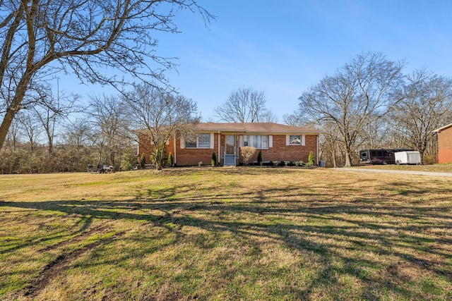 view of front of property featuring a front lawn and brick siding