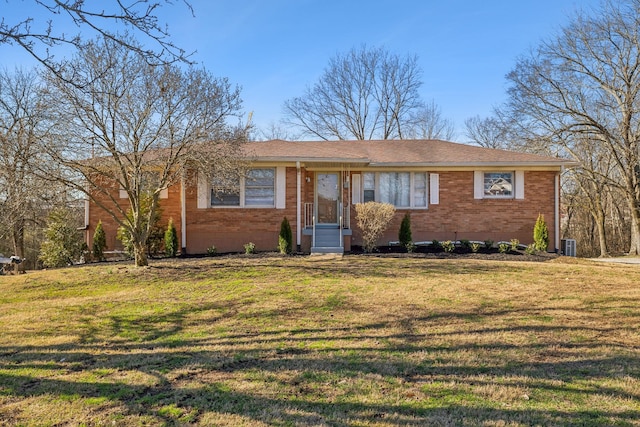 single story home featuring brick siding and a front yard