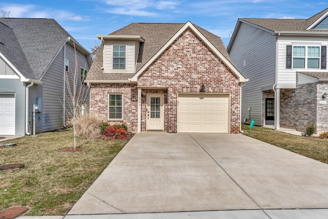 view of front of house with brick siding, a shingled roof, a garage, driveway, and a front lawn