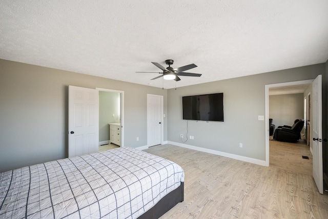 bedroom featuring a textured ceiling, ceiling fan, light wood-type flooring, and baseboards