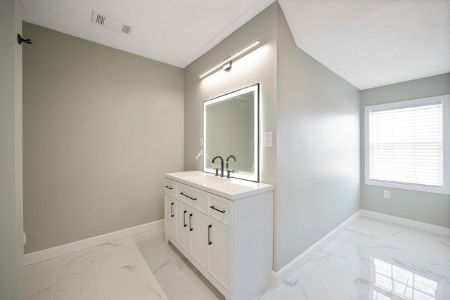 bathroom featuring baseboards, visible vents, marble finish floor, a textured ceiling, and vanity