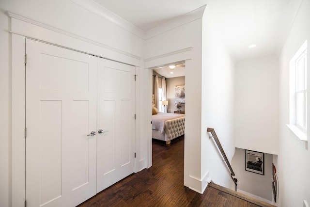 hallway with dark wood-style floors and an upstairs landing