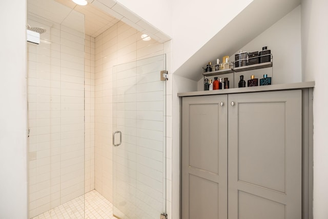 bathroom featuring lofted ceiling and a stall shower