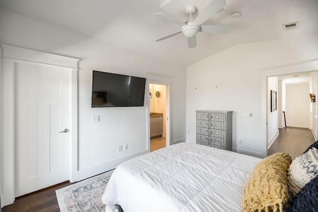 bedroom with visible vents, vaulted ceiling, baseboards, and wood finished floors