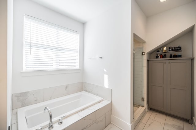 full bathroom with a garden tub, a shower stall, and marble finish floor