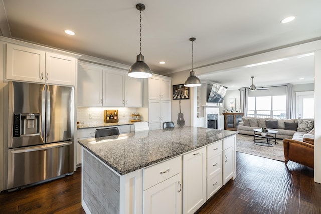 kitchen featuring a center island, white cabinetry, stainless steel refrigerator with ice dispenser, decorative backsplash, and dark wood finished floors