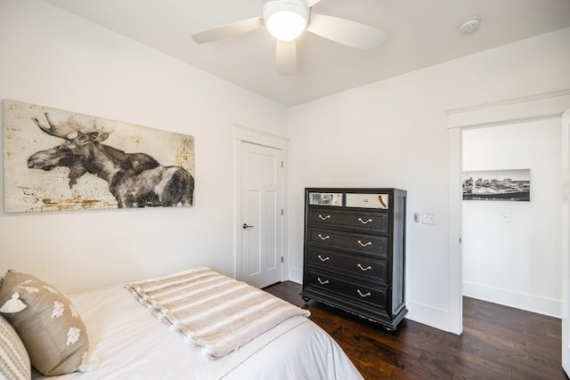 bedroom with dark wood-style floors, ceiling fan, and baseboards