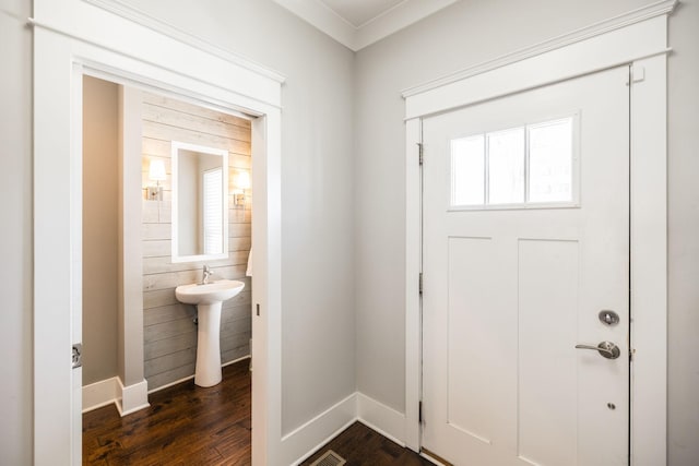 foyer with baseboards and dark wood finished floors