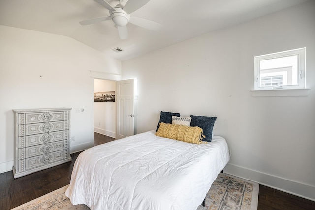 bedroom with a ceiling fan, baseboards, vaulted ceiling, and wood finished floors