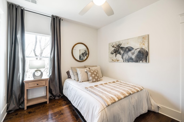 bedroom with baseboards, a ceiling fan, and wood finished floors