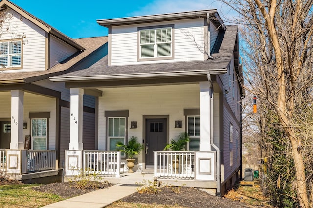 view of front of house with central AC unit, a porch, and roof with shingles