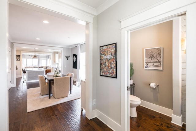 interior space with baseboards, dark wood-style flooring, crown molding, and recessed lighting