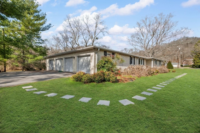 view of side of home featuring a yard and brick siding