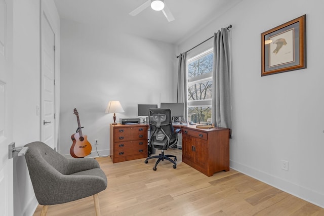 office space featuring light wood finished floors, baseboards, and a ceiling fan