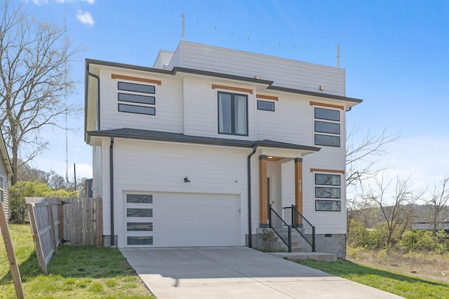 view of front of home with fence, driveway, and an attached garage