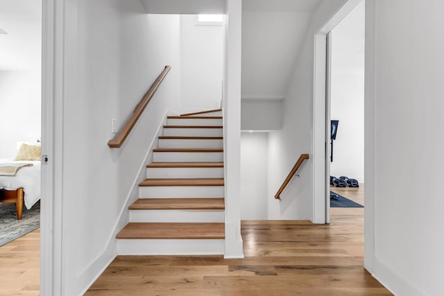 stairway with wood finished floors