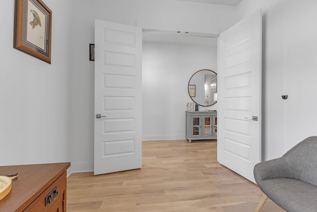 sitting room featuring light wood-type flooring and baseboards