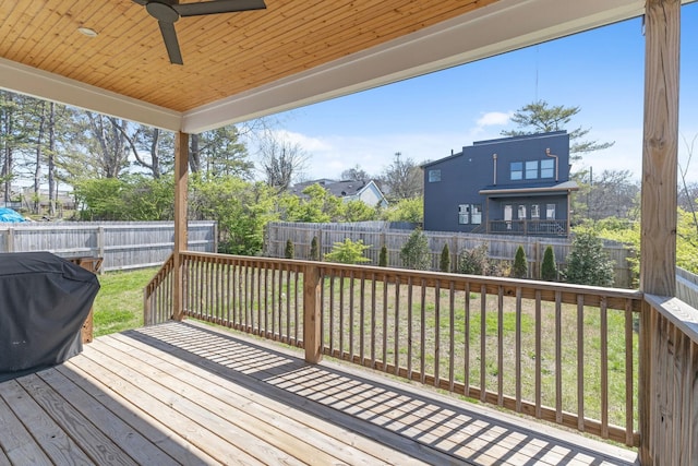 wooden deck featuring a grill, a fenced backyard, and ceiling fan