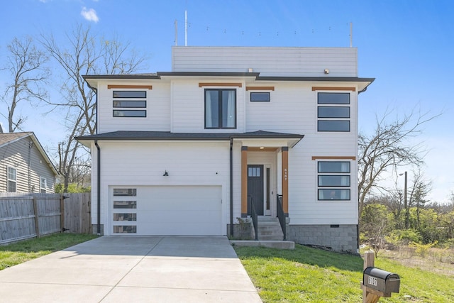 modern home with driveway, an attached garage, fence, and a front lawn