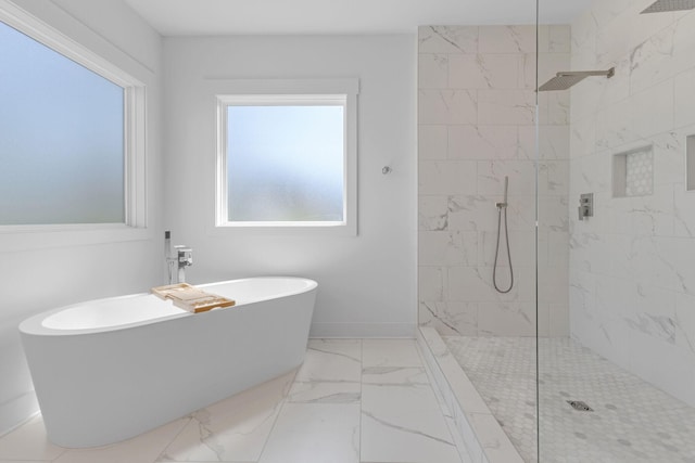 full bath featuring marble finish floor, a marble finish shower, baseboards, and a freestanding bath