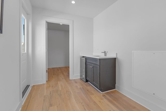 bathroom featuring recessed lighting, vanity, baseboards, and wood finished floors