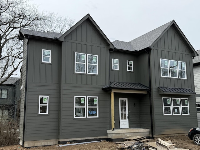 modern farmhouse featuring a standing seam roof, a shingled roof, metal roof, and board and batten siding