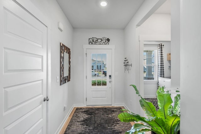 doorway to outside featuring baseboards