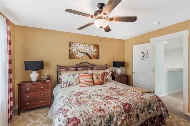 bedroom featuring light carpet, baseboards, and a ceiling fan