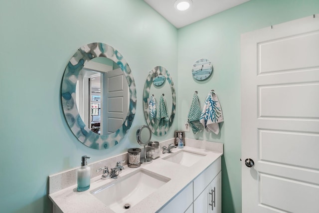 bathroom featuring a sink and double vanity