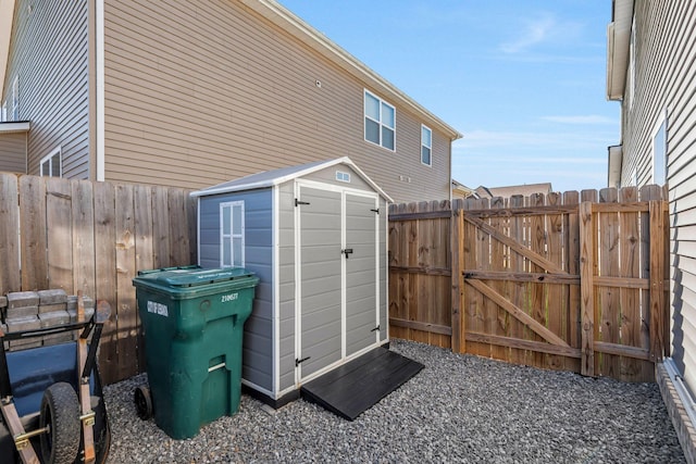 view of shed with a gate and fence