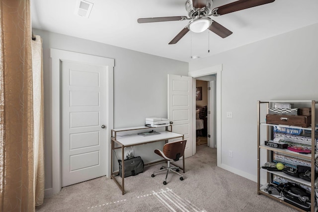 carpeted home office with ceiling fan, visible vents, and baseboards