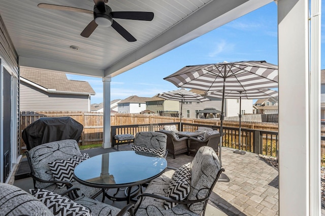 view of patio with a residential view, a grill, a ceiling fan, and fence