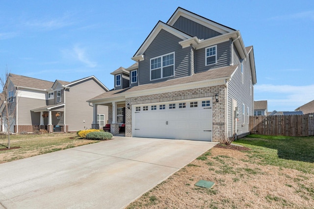 craftsman inspired home featuring concrete driveway, an attached garage, fence, board and batten siding, and a front yard