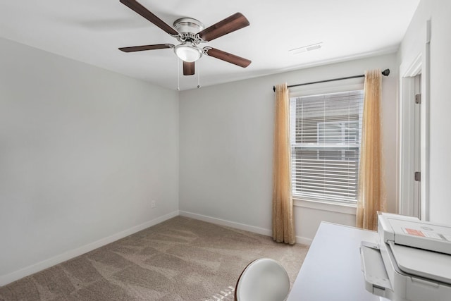 home office featuring carpet, visible vents, baseboards, and ceiling fan