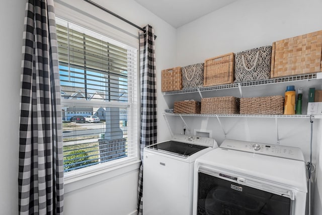 clothes washing area with washing machine and dryer and laundry area