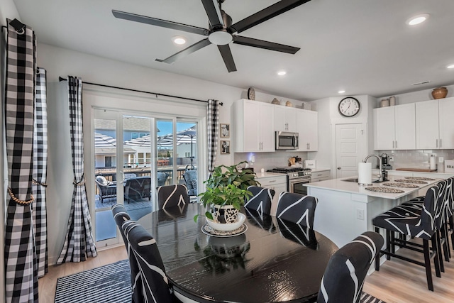 dining area with recessed lighting, a ceiling fan, and light wood-style floors