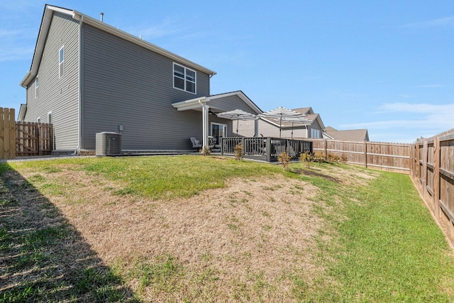 back of house with a yard, cooling unit, and a fenced backyard