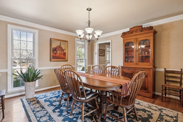 dining space with hardwood / wood-style flooring and wallpapered walls