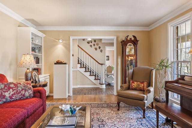 living room with crown molding, stairs, baseboards, and wood finished floors