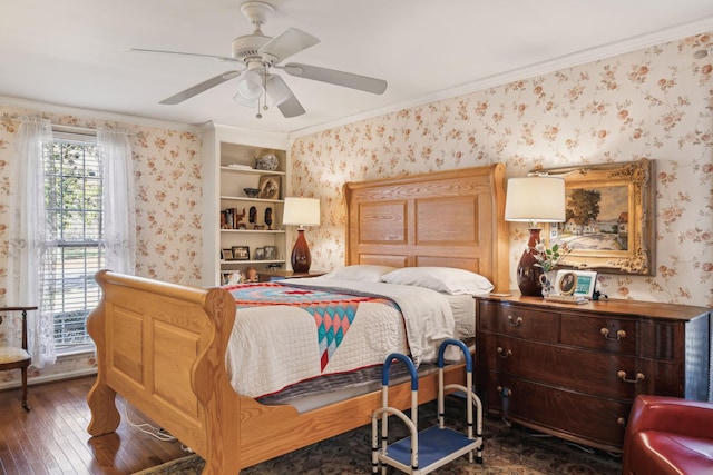 bedroom with dark wood-style floors, a ceiling fan, crown molding, and wallpapered walls