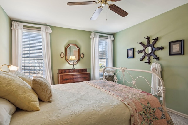 bedroom with carpet floors, ceiling fan, and baseboards