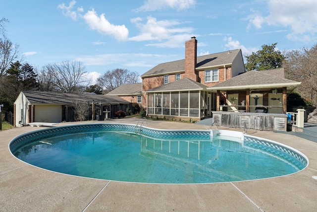 pool with a sunroom and a patio area