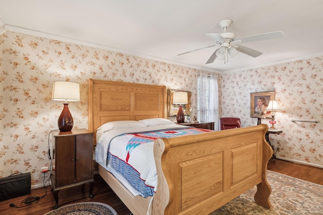 bedroom with wallpapered walls, baseboards, a ceiling fan, wood finished floors, and crown molding