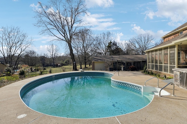 outdoor pool featuring a sunroom, a patio, and fence