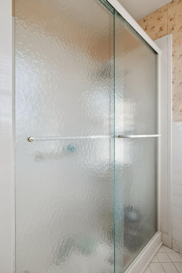 full bathroom featuring a stall shower and tile patterned floors