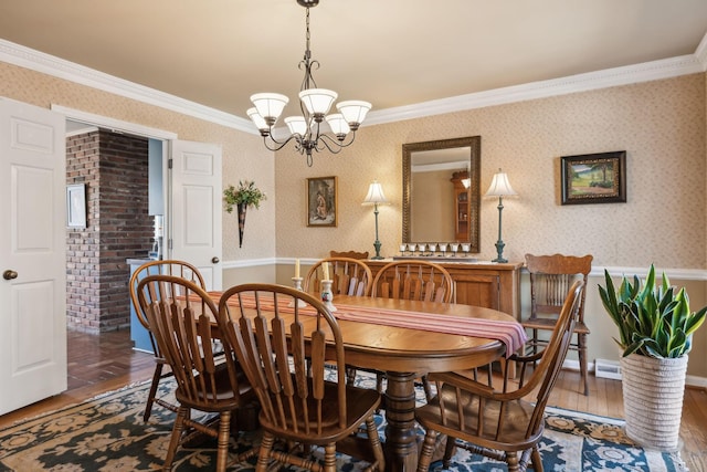 dining room with wallpapered walls, crown molding, hardwood / wood-style floors, and an inviting chandelier